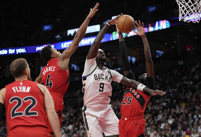Toronto Raptors forward Scottie Barnes (4) and forward Chris Boucher (25) block a shot by Milwaukee Bucks forward Bobby Portis (9)